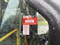 A 2019 Chevrolet Express with a wet window displaying a red certificate of approval sticker showing the years 2025 and 2026 along with the months January to May