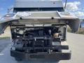 A 2012 Ford Econoline with the hood raised exposing the engine compartment