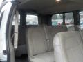 Interior of a 2011 Chevrolet Express showing grey fabric seats with seatbelts and a spacious layout