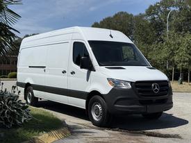 A 2019 Mercedes-Benz Sprinter van in white with a black lower trim featuring a sleek design and large cargo space ideal for transport and delivery purposes