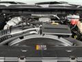 Close-up view of the engine compartment of a 2022 GMC Sierra 3500HD showcasing the engine components and the air intake system