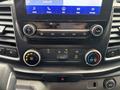 Dashboard controls of a 2020 Ford Transit 250 with buttons for audio volume climate settings and a touchscreen display