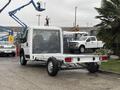 A 2023 RAM Promaster 3500 chassis cab vehicle with an open cargo area and no rear panel is shown, featuring a white exterior and visible wheels