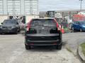 A black 2014 Honda CR-V parked in a lot showing its rear view with no visible license plate