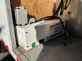 A Xantrax T240 power inverter positioned inside a truck with visible electrical connections and a worn exterior
