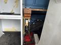 A 2006 Ford Econoline is parked with its door open revealing an interior filled with various tools and equipment including a battery and a measuring device