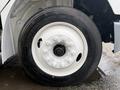 A close-up view of a white wheel on a 2019 Freightliner M2 featuring six lug nuts surrounding a black hub and a tire labeled 255/70R22.5
