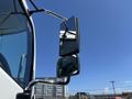 A side mirror of a 2020 Hino 338 showing two reflective surfaces mounted on an adjustable arm
