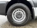 Close-up of the wheel of a 2017 Mercedes-Benz Sprinter featuring a Yokohama Geolandar A/T tire with a silver wheel rim and circular vent holes