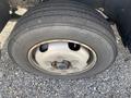 Close-up of a tire from a 2019 Hino 195 featuring a steel rim and six lug nuts with visible tread pattern on the rubber surface