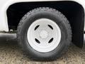 A close-up of a white wheel from a 2017 Ford E450 featuring a rugged black tire with the name Discoverer AT3 LT engraved on its sidewall