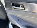 Interior door handle of a 2015 Hyundai Sonata with a metal finish and a button for power window control