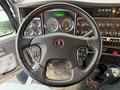 Close-up of the steering wheel and dashboard of a 2018 Kenworth T800 showcasing various gauges and controls