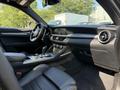 Interior of a 2020 Alfa Romeo Stelvio featuring black leather seats a sleek dashboard and a modern center console with controls and gear shifter