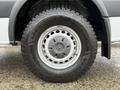 A close-up view of a Goodyear Wrangler tire mounted on a 2017 Mercedes-Benz Sprinter showcasing its tread design and the Mercedes-Benz logo on the hubcap
