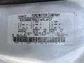 A 2015 Ford F-750 truck with a vehicle information label detailing specifications such as weight limits and tire sizes