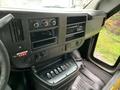 Interior dashboard of a 2015 Chevrolet Express showing control knobs and a panel with various switches and buttons