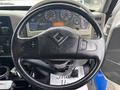Steering wheel of a 2013 International DuraStar 4300 with various gauges and controls visible in the background