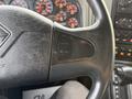 Close-up of the steering wheel of a 2013 International Durastar 4300 featuring buttons for cruise control labeled "CHUISE" and "RESUME/ACCEL"