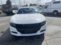 A white 2017 Dodge Charger with a sleek front design featuring a wide grille and sporty headlights