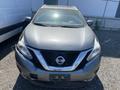 A 2017 Nissan Murano in gray with a distinctive V-shaped grille and the Nissan logo prominently displayed on the front