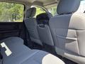 Interior view of a 2013 RAM 2500 showing the backseat area with gray fabric upholstery and a center console between the two front seats