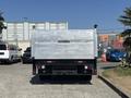 A 2019 Ford F-550 flatbed truck with a silver body and a Tommy Gate lift on the rear facing towards the viewer