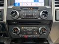 The dashboard controls of a 2018 Ford F-150 featuring audio and climate control buttons with a central display screen