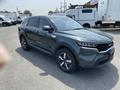 A 2022 Kia Sorento in green with a sleek design, featuring a bold front grille and stylish wheels, positioned at an angle for visibility