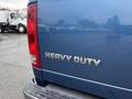 A blue 2006 Dodge Ram 2500 with the text HEAVY DUTY in chrome letters on the rear tailgate