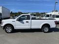 A white 2018 Ford F-150 pickup truck with a single cab and bed shown from the side