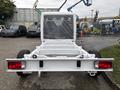 A white 2023 RAM Promaster 3500 chassis viewed from the rear showing the open cargo area and taillights