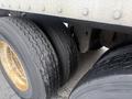 Close-up view of three truck tires showing worn tread patterns and some rust on the rims