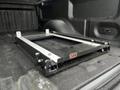 A black ARB sliding drawer system is installed in the bed of a 2014 Ford F-150