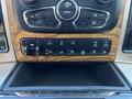 Dashboard controls of a 2015 RAM 1500 featuring climate control knobs buttons for towing and seat heating settings