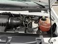 Close-up view of the engine compartment of a 2017 Ford E450 showing various engine components including hoses and a fluid reservoir