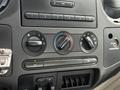 Dashboard controls of a 2008 Ford F-250 SD featuring knobs for climate control and audio settings