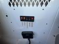 A control panel with multiple switches and labeled indicators for traffic, strobe, generator, and bucket features