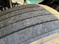 Tread of a tire from a 2012 Freightliner M2 106 showing visible wear and grooves with some cracking on the surface
