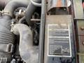 A close-up view of a 2015 Kubota F3990 engine showing various components and a label with important operational instructions