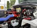 A close-up view of the engine compartment of a 2021 Freightliner M2 106 showcasing various mechanical components including hoses tanks and electrical systems