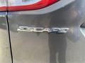 Close-up of the rear emblem on a 2016 Ford Escape displaying the word Escape in silver lettering