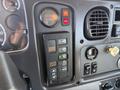 Control panel of a 2010 Freightliner M2 106 featuring various switches and indicators for operations and functions
