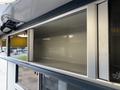 The interior storage compartments of a 2020 Mercedes-Benz Sprinter 2500 with sleek metal finishes and ample space
