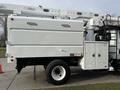 Side view of a 2011 International 4300 utility truck with a white body and equipment mounted on top including a bucket lift arm