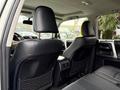 Interior view of a 2018 Toyota 4Runner featuring black leather seats and a spacious back row with headrests and storage pockets