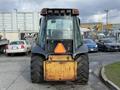 A rear view of a 2005 Case 570 tractor with large tires and an orange hazard sign on the back