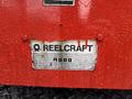 A close-up of a metal label affixed to a red surface reading Reelcraft 4000 with a weathered appearance and raindrops on it