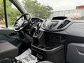 Interior of a 2017 Ford Transit T150 XLT featuring a dashboard with controls a steering wheel and seating area along with a floor mat that says Thank You