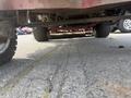A 2013 Toro Grounds Master 5910 with visible undercarriage components and large tires positioned on a paved surface